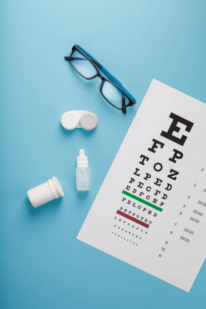 istock Ophthalmic Accessories Glasses and lenses with an Eye Test Chart for vision correction on a blue background 1368785724