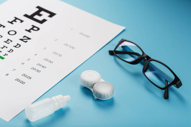 istock Ophthalmic Accessories Glasses and lenses with an Eye Test Chart for vision correction on a blue background 1368785915