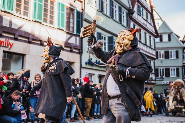 Swabian Fasnet - Colorful carnival Tuebingen, Germany - February 09, 2020: Swabian Fasnet - Colorful carnival procession on the street of the old town of Tübingen - Swabian-Alemannic Fasnet is a pagan affair with old traditions fasnacht festival stock pictures, royalty-free photos & images