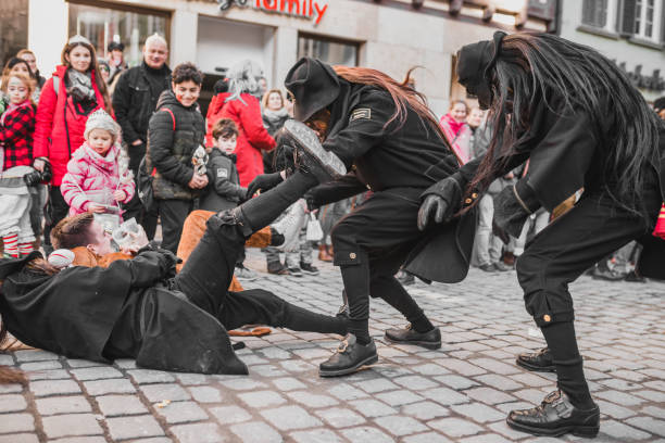 Tuebingen, Germany - February 09, 2020: Swabian Fasnet - Colorful carnival procession on the street of the old town of Tübingen - Swabian-Alemannic Fasnet is a pagan affair with old traditions