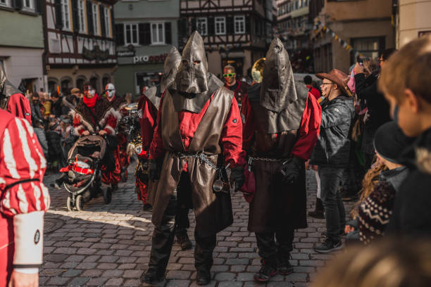 Swabian Fasnet - Colorful carnival Tuebingen, Germany - February 09, 2020: Swabian Fasnet - Colorful carnival procession on the street of the old town of Tübingen - Swabian-Alemannic Fasnet is a pagan affair with old traditions fasnacht festival stock pictures, royalty-free photos & images