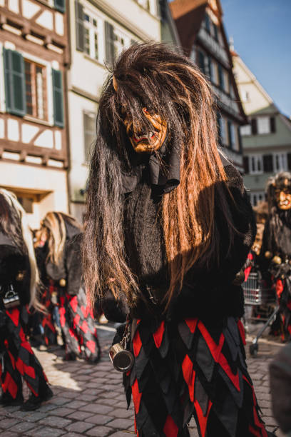 Swabian Fasnet - Colorful carnival Tuebingen, Germany - February 09, 2020: Swabian Fasnet - Colorful carnival procession on the street of the old town of Tübingen - Swabian-Alemannic Fasnet is a pagan affair with old traditions fasnacht festival stock pictures, royalty-free photos & images