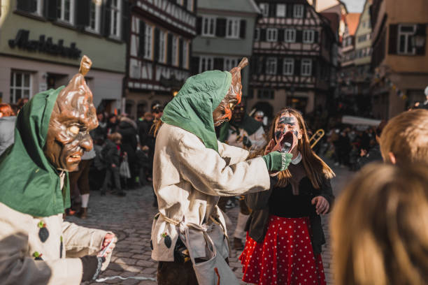 Swabian Fasnet - Colorful carnival Tuebingen, Germany - February 09, 2020: Swabian Fasnet - Colorful carnival procession on the street of the old town of Tübingen - Swabian-Alemannic Fasnet is a pagan affair with old traditions fasnacht festival stock pictures, royalty-free photos & images