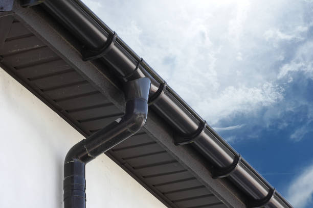 istock View of brown roof with gutter drain and blue sky. 1368790528