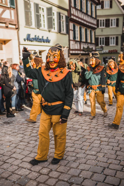 Swabian Fasnet - Colorful carnival Tuebingen, Germany - February 09, 2020: Swabian Fasnet - Colorful carnival procession on the street of the old town of Tübingen - Swabian-Alemannic Fasnet is a pagan affair with old traditions fasnacht festival stock pictures, royalty-free photos & images