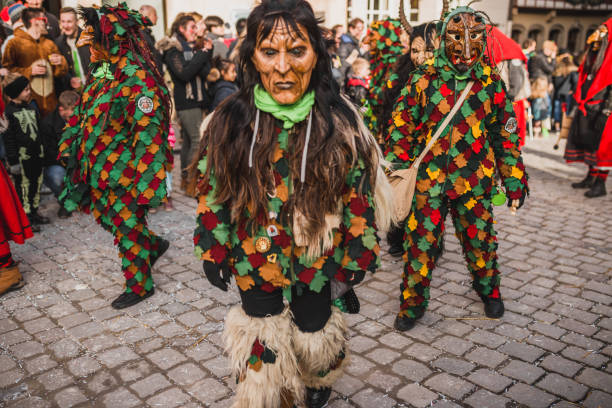 Swabian Fasnet - Colorful carnival Tuebingen, Germany - February 09, 2020: Swabian Fasnet - Colorful carnival procession on the street of the old town of Tübingen - Swabian-Alemannic Fasnet is a pagan affair with old traditions fasnacht festival stock pictures, royalty-free photos & images