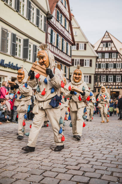 Swabian Fasnet - Colorful carnival Tuebingen, Germany - February 09, 2020: Swabian Fasnet - Colorful carnival procession on the street of the old town of Tübingen - Swabian-Alemannic Fasnet is a pagan affair with old traditions fastnacht stock pictures, royalty-free photos & images