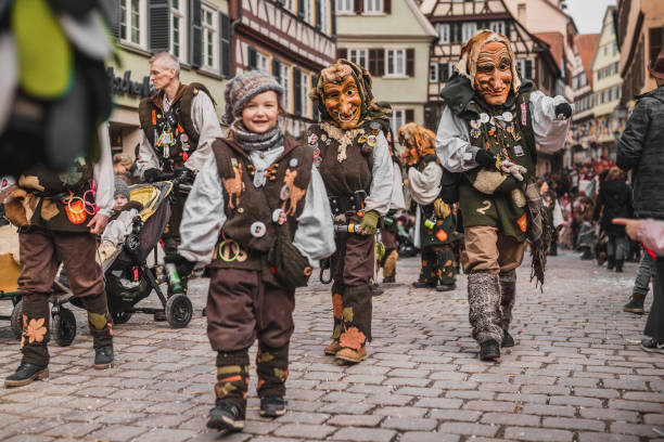 Swabian Fasnet - Colorful carnival Tuebingen, Germany - February 09, 2020: Swabian Fasnet - Colorful carnival procession on the street of the old town of Tübingen - Swabian-Alemannic Fasnet is a pagan affair with old traditions fasnacht festival stock pictures, royalty-free photos & images