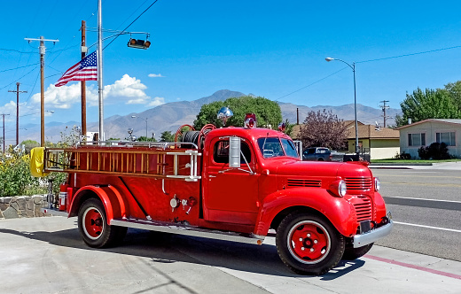 In Winter Garden, United States a stationary vintage red fire truck is displayed outside of the museum in the downtown area.