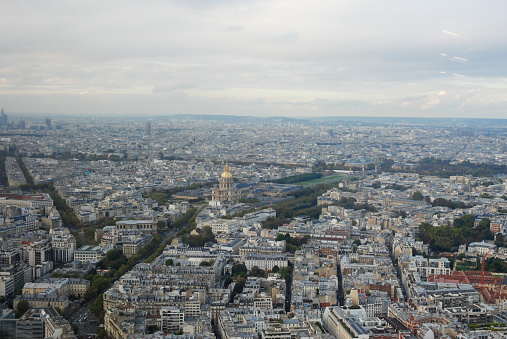 High angle wide shot/panoramic of the Paris skyline. Image is taken from the view at the top of the Tour Montparnasse.
