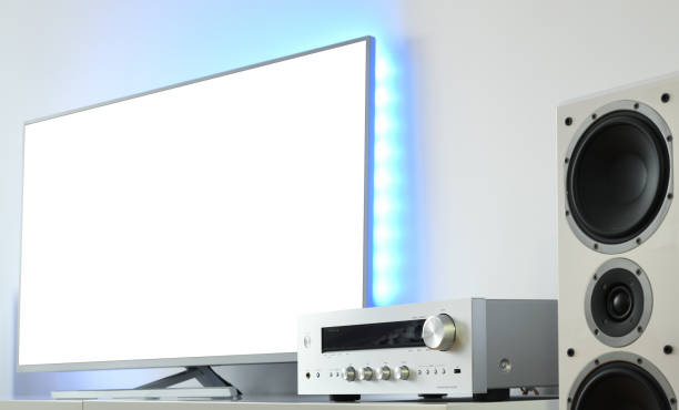 istock Large backlit LED TV with white screen and audio receiver in a modern apartment. 1368791478