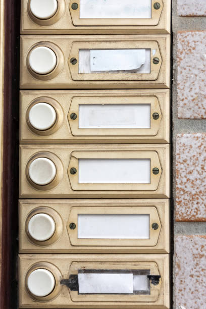 Intercom or bell button on an apartment entrance with rows if blank labels for names in order to gain entry to a resident