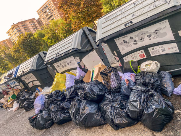 Valencia, Spain - September 12, 2021: Lots of plastic bags stacked next to containers. Sometimes the garbage is that much that doesn't fit into the containers