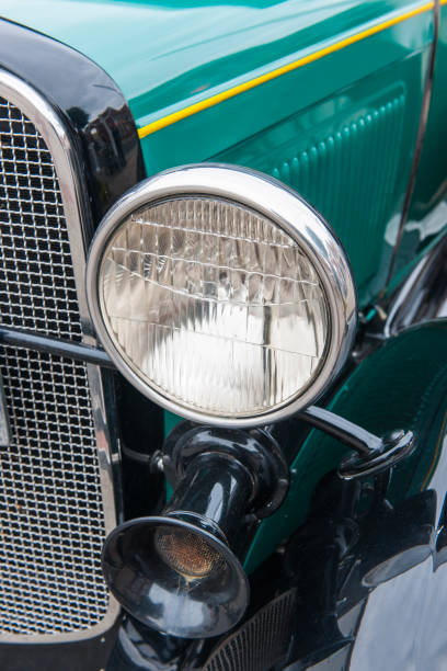 istock Headlight of an olive green classic car 1368794986