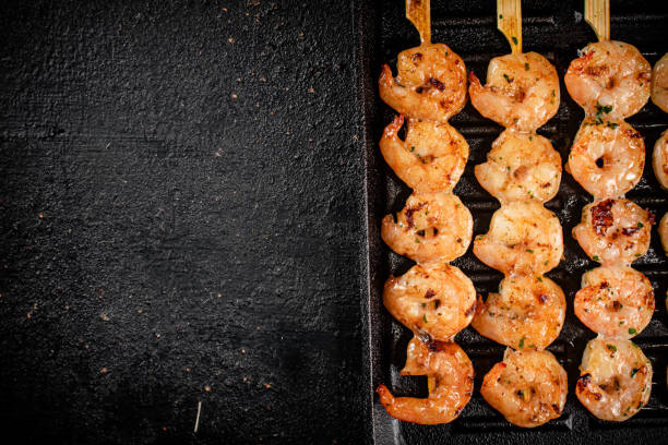 istock Shrimp on skewers are grilled in a grill pan. 1368794989