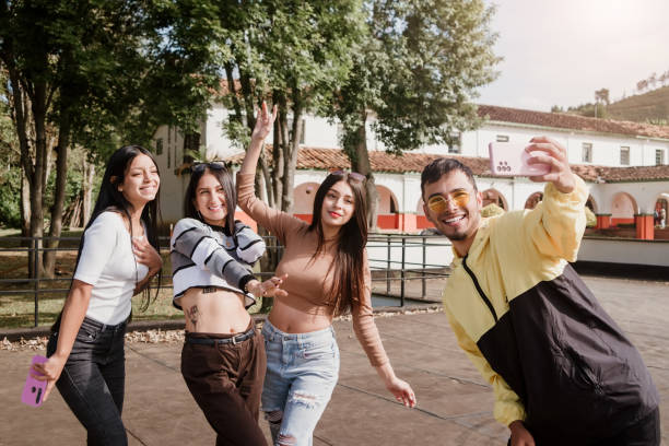 Group of happy and smiling friends taking a selfie on a sunny morning stock photo
