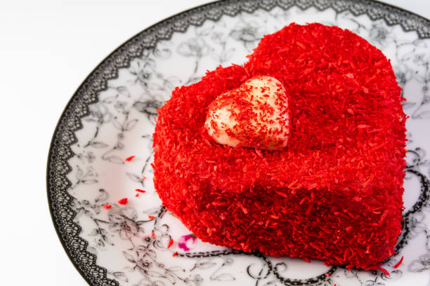 istock Red heart shaped cake on black and white plate on white background 1368799257