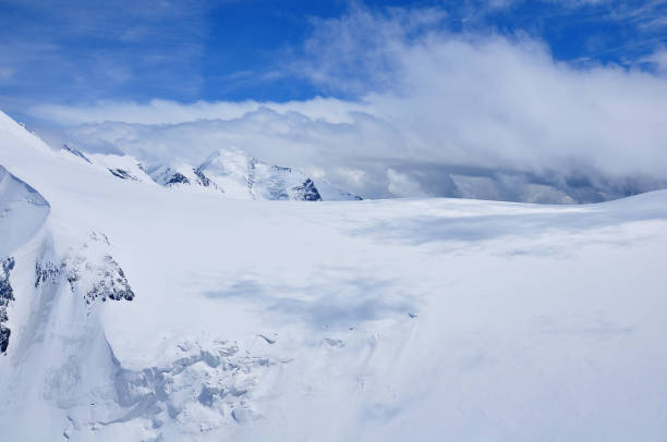 istock Clouds above the snowy mountains near Zermatt. 1368799360