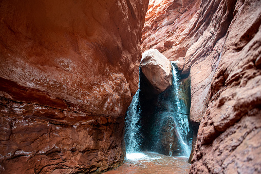 Waterfall at the end of a slot canyon hike in Moab, Utah in Moab, Utah, United States