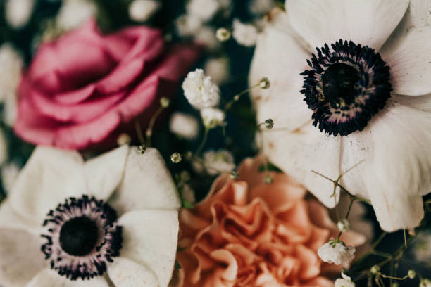 istock Close up of spring flower arrangement against teal cloth backdrop 1368800792