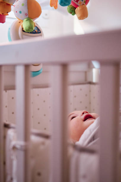istock Baby playing with musical crib mobile 1368801012