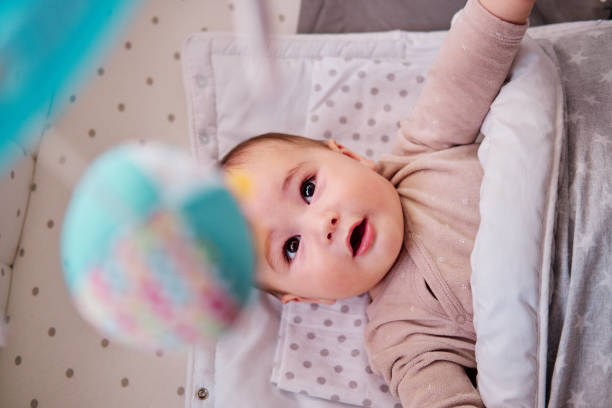 istock Baby playing with musical crib mobile 1368801061