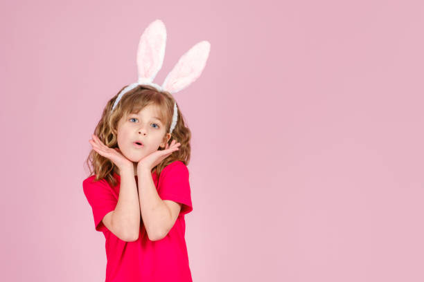 istock Surprised cute little girl in Easter bunny ears headband 1368802048