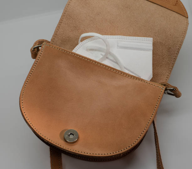 istock face mask in a brown leather bag 1368803420