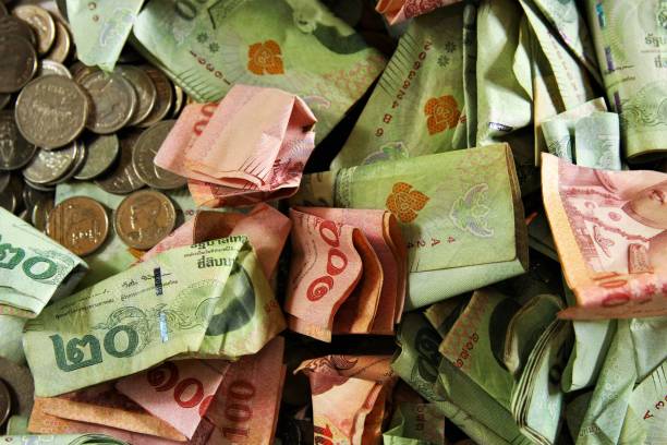 istock Thai banknotes and coins 1368804771
