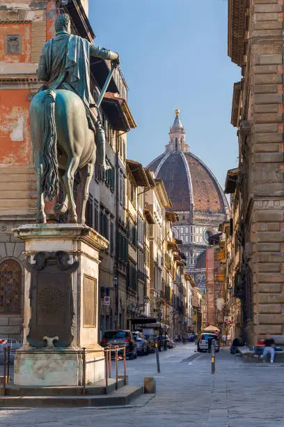 Photo of Duomo of Florence from distance with horse statue in the foreground