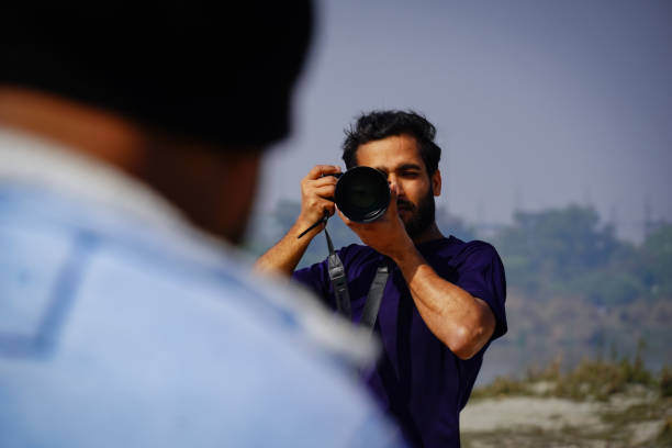 istock cameraman Taking a picture with a camera 1368805710