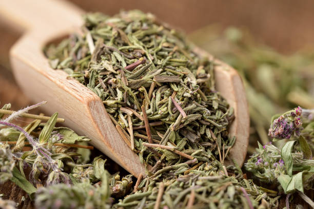 istock Dried chopped thyme in a wooden scoop 1368810687