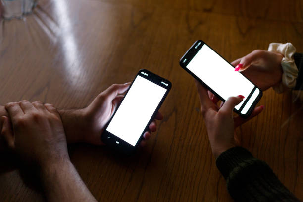 istock Unrecognizable persons are using a phone to search on the internet with blank screen 1368814380