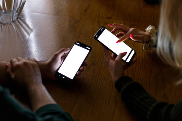 istock Unrecognizable persons are using a phone to search on the internet with blank screen 1368814384