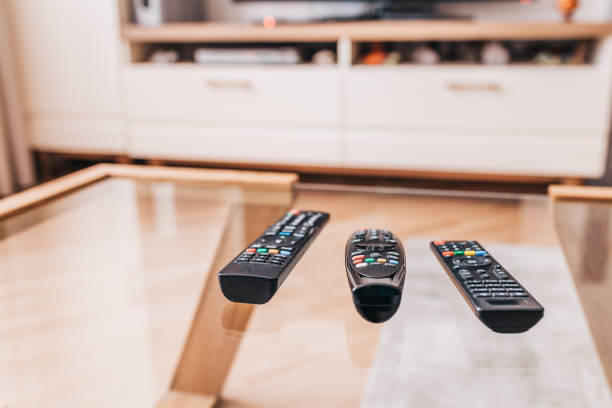 Remote controls on the coffee table Remote controls on the coffee table - a place on the couch for relaxing and watching the media center - TV, DVD remote control on table stock pictures, royalty-free photos & images