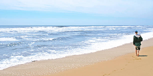 istock teen boy on beach 136881558