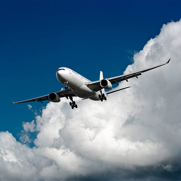 istock XXL jet airplane landing in cloudy sky 136881590