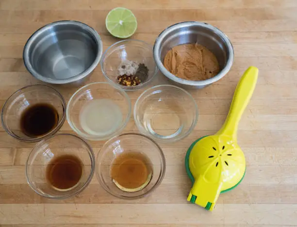Ingredients on cutting board with lemon /lime squeezer