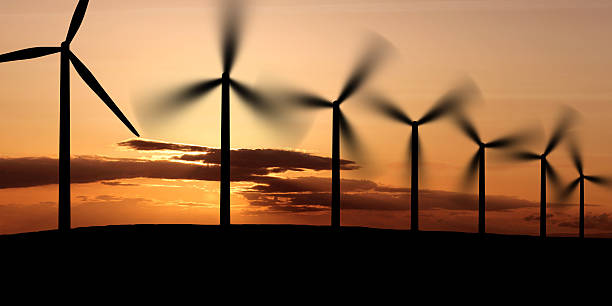 XL wind farm sunset wind farm in silhouette at sunset, panoramic frame (XL) landscape alternative energy scenics farm stock pictures, royalty-free photos & images