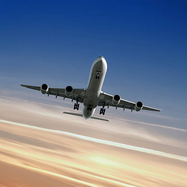 istock XL jet airplane landing at dusk 136881687