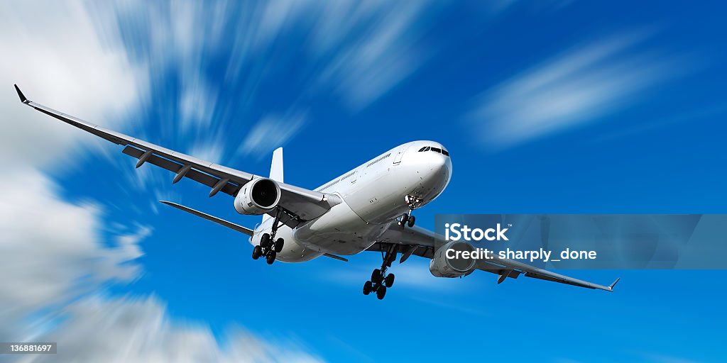 jet airplane landing in motion blur sky jet airplane landing in bright motion blur sky, panoramic frame Airplane Stock Photo