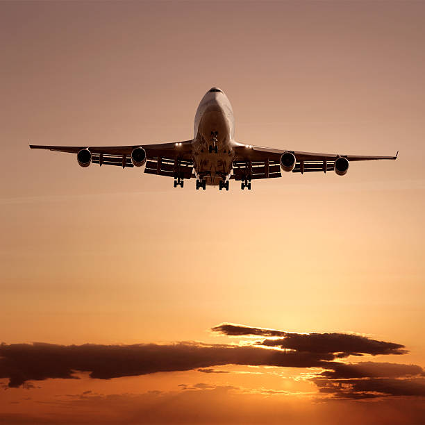 istock XL jumbo jet airplane landing at dusk 136881715