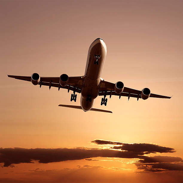 istock XL jet airplane landing at dusk 136881717