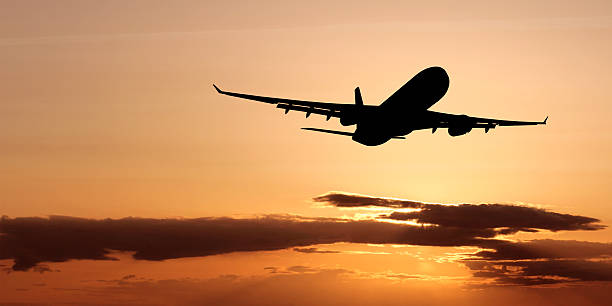 XL jet airplane taking off at dusk stock photo