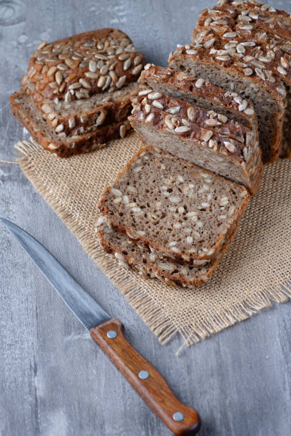 istock Sliced rye bread on cutting board. Whole grain rye bread with seeds 1368817787