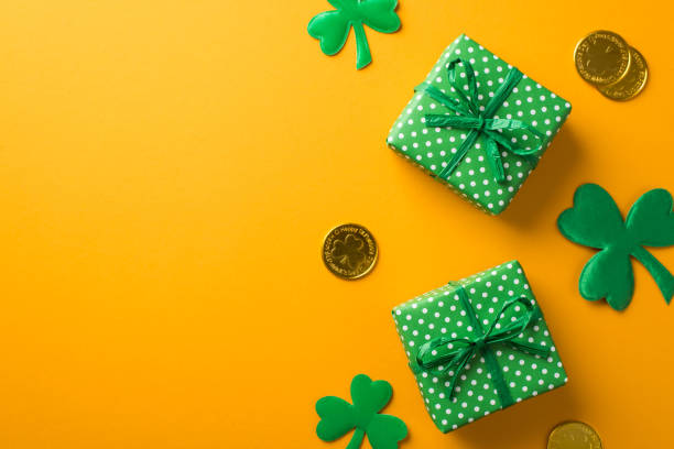 istock Top view photo of st patrick's day decorations two green gift boxes with polka dot pattern shamrocks and gold coins on isolated yellow background with empty space 1368818568