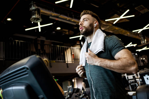 istock Young man running on a treadmill 1368818734