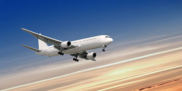 istock XL jet airplane landing at dusk 136882010