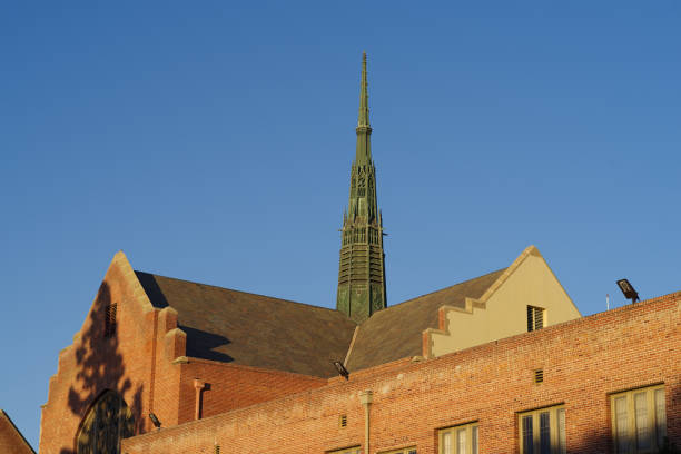 Pasadena, California, USA - February 4, 2022:  this image shows the rooftop and steeple of the First United Methodist Church against a blue, afternoon sky.