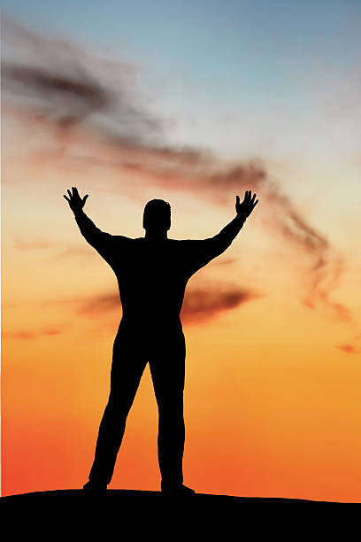 xxl reverent mann silhouette - applauding contemplation praying arms outstretched stock-fotos und bilder